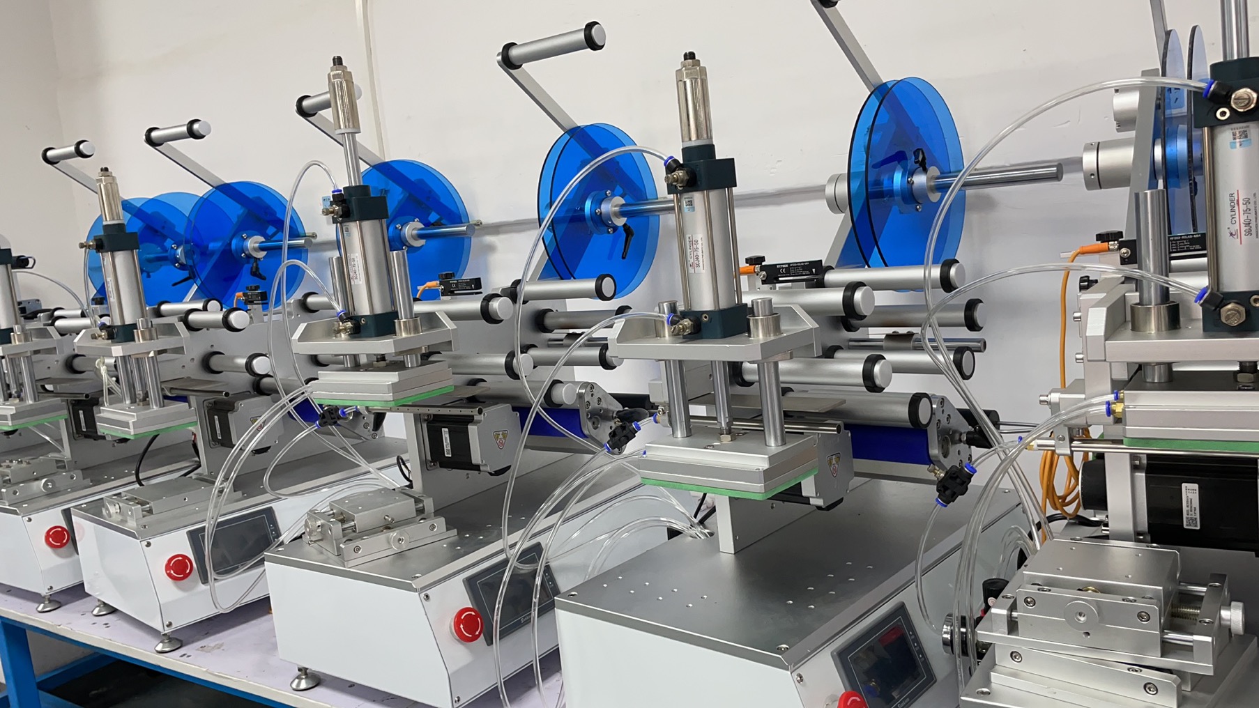 Rows of precision labeling machines in final assembly at the HiPaks factory