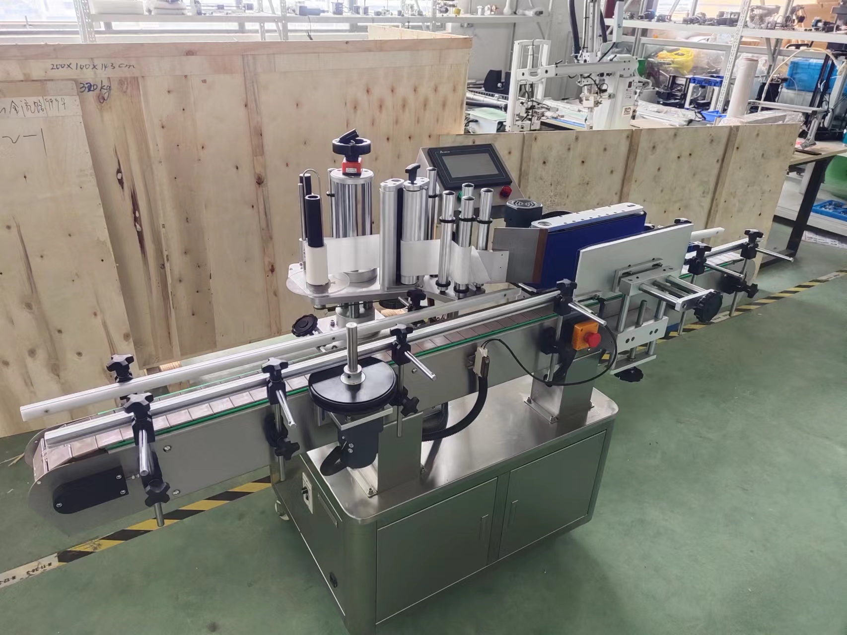 HiPaks T921 automatic round bottle labeling machine applying wrap-around labels inline