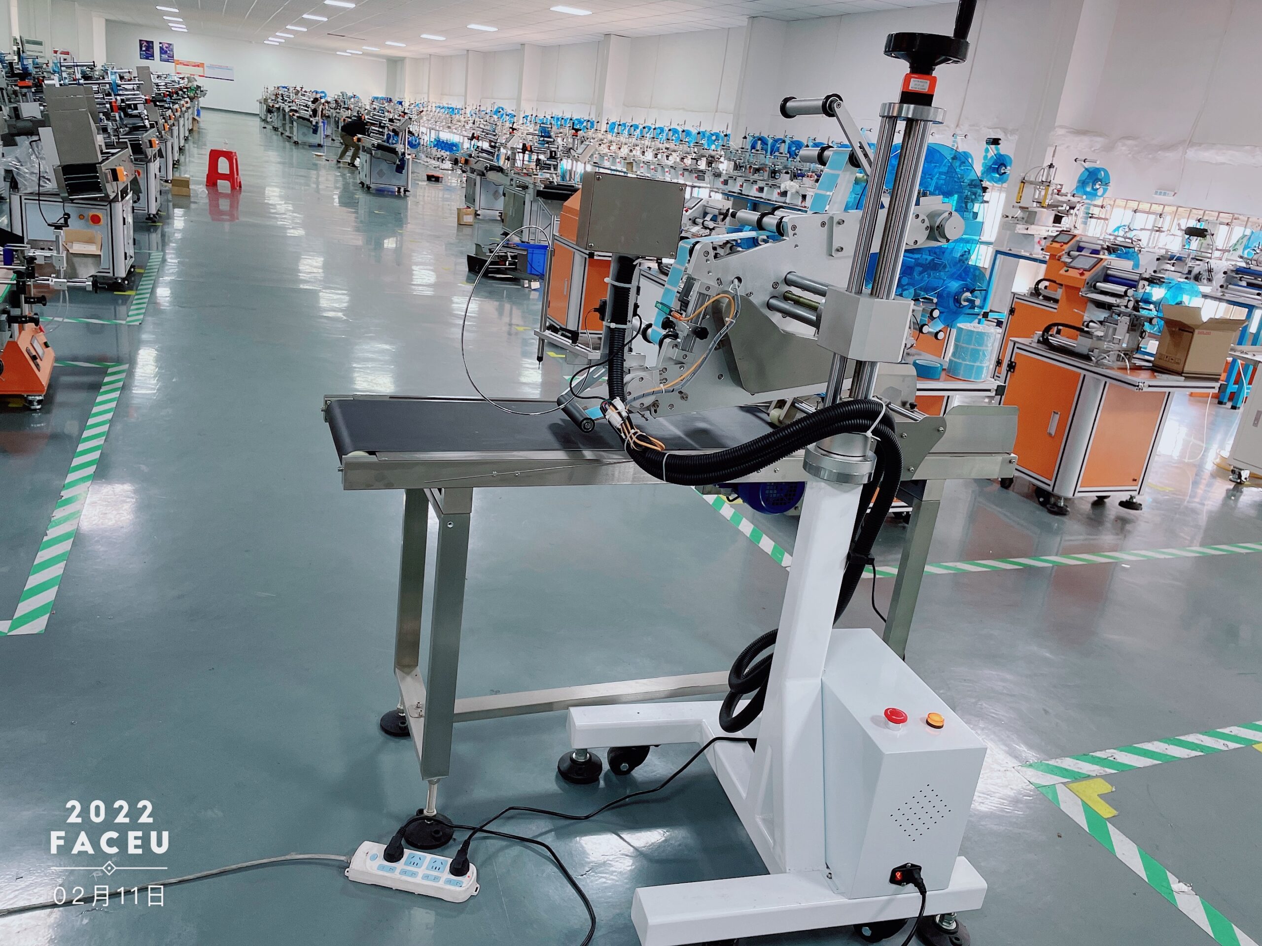 T951 inline flat labeling applicator module installed on a conveyor